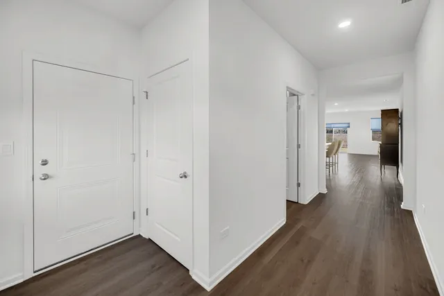 a view of hallway with wooden floor
