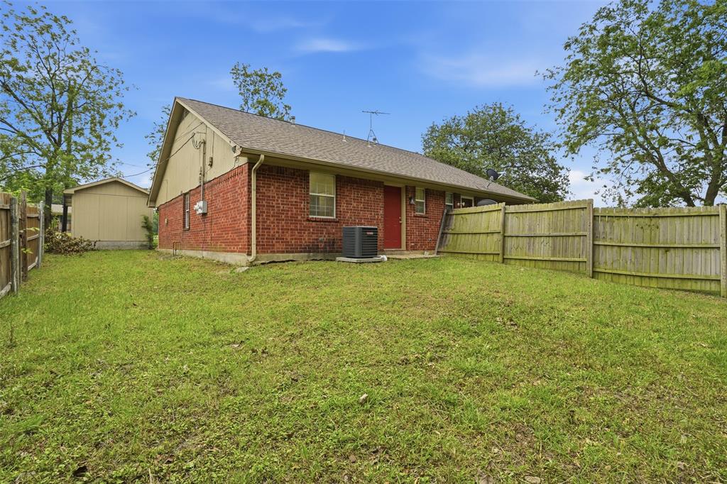 106 Shaw Street, Unit 106 Tom Bean, TX 75491 - Photo 20 of 25 a view of a backyard with a small cabin