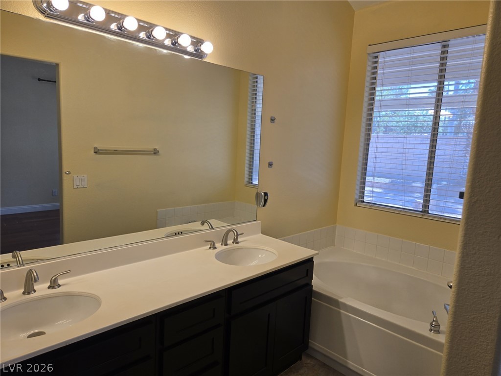 8417 San Ramon Drive Las Vegas, NV 89147 - Photo 18 of 33 Dual vanities and a deep soaking tub create a functional and relaxing bathing space.