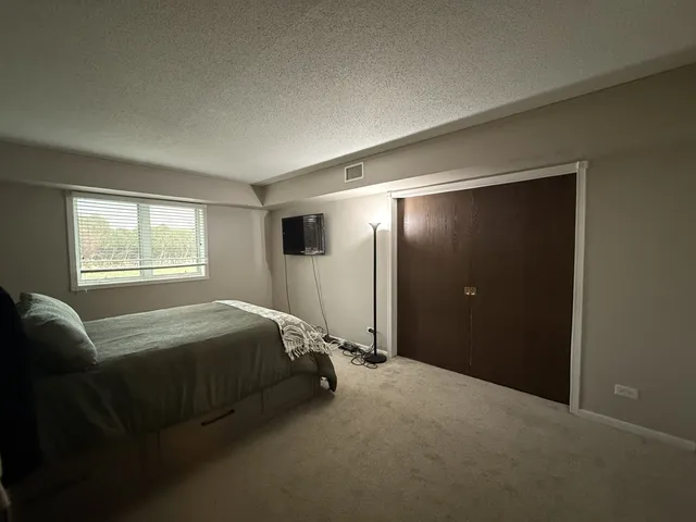 a bed room with a bed and a window