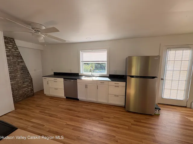 a kitchen with a refrigerator a sink and cabinets