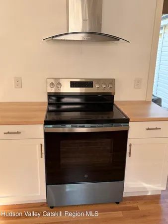 a stove top oven sitting inside of a kitchen