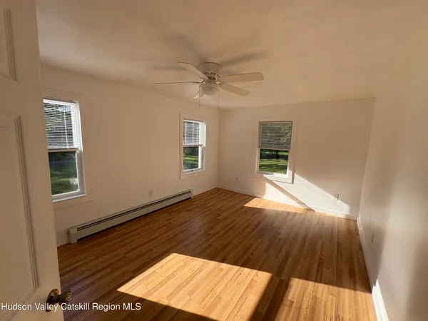 wooden floor in an empty room with a window