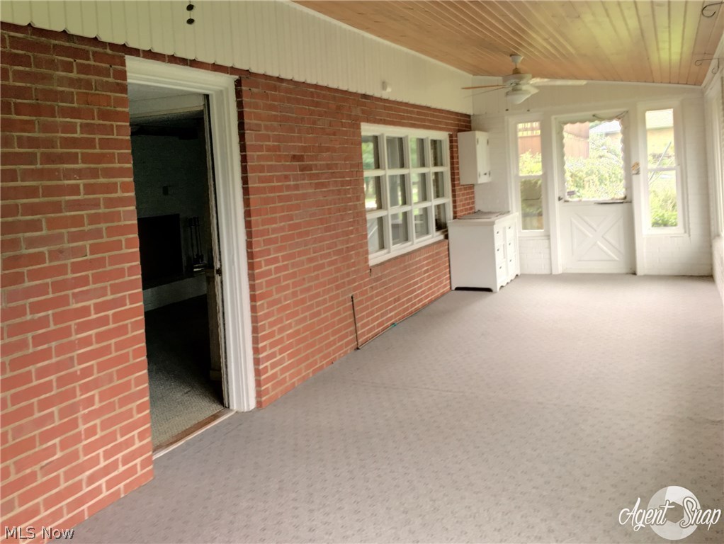 2601 Ridgedale Avenue Northwest Canton, OH 44708 - Photo 19 of 24 Easy access to the backyard from yet more living space in the three season room.