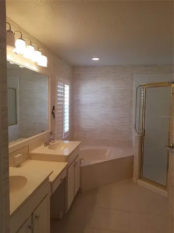 a bathroom with a granite countertop sink a toilet and bathtub