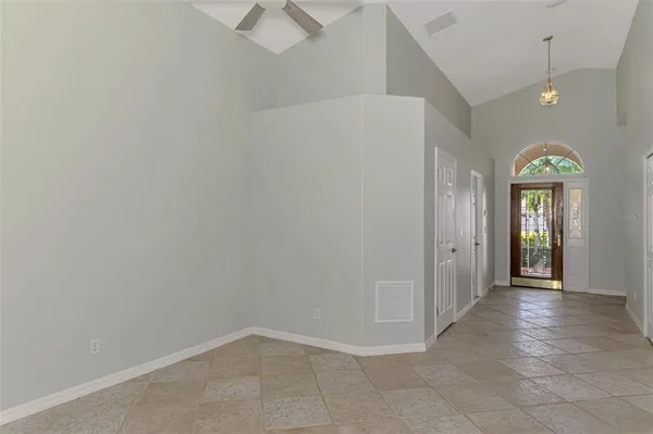 a view of a livingroom with a ceiling fan and window