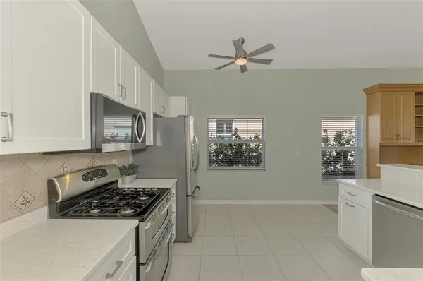 a view with granite countertop a sink and window