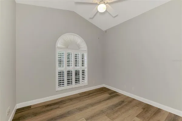 a view of an empty room with wooden floor