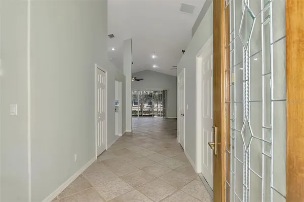 a view of a hallway with a view of a bathroom