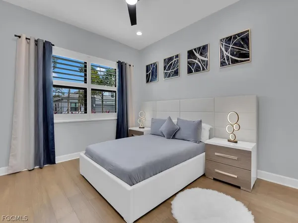 a bedroom with a bed and a large window