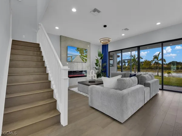 a living room with furniture and a floor to ceiling window