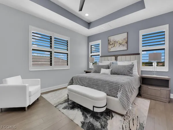 a spacious bedroom with a bed a couch and a window