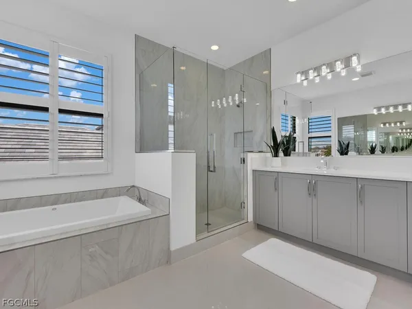 a large spacious bathroom with a large tub shower and sink