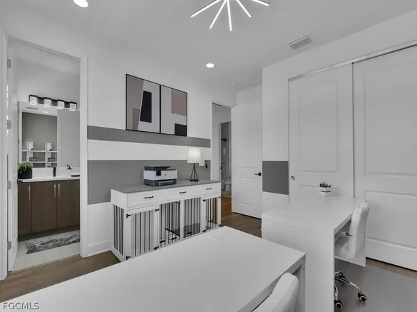 a kitchen that has a sink a stove and chairs