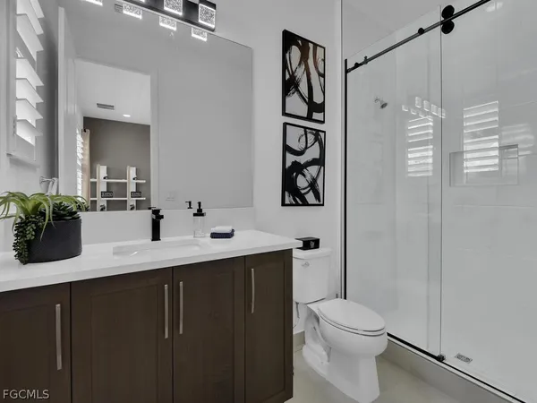 a bathroom with a toilet sink shower and mirror