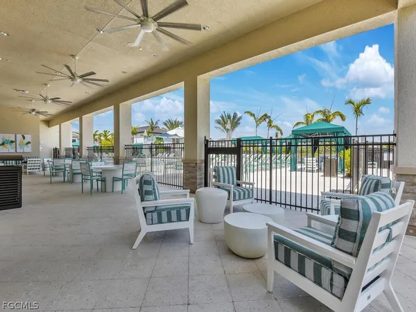 a view of a patio with couches table and chairs potted plants and palm tree