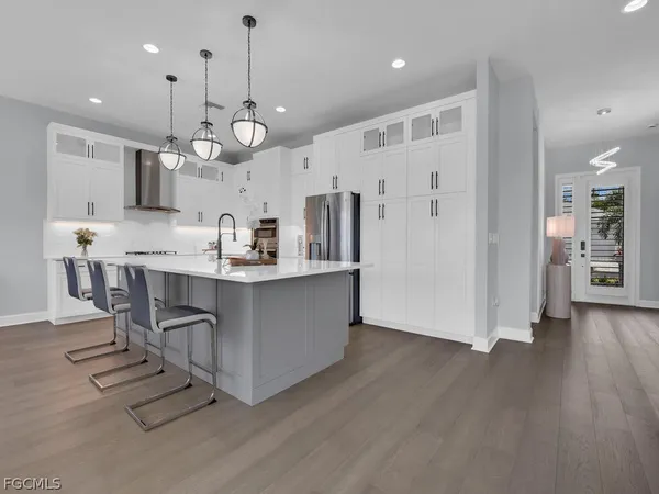 a kitchen with stainless steel appliances kitchen island a island in the center and wooden floors