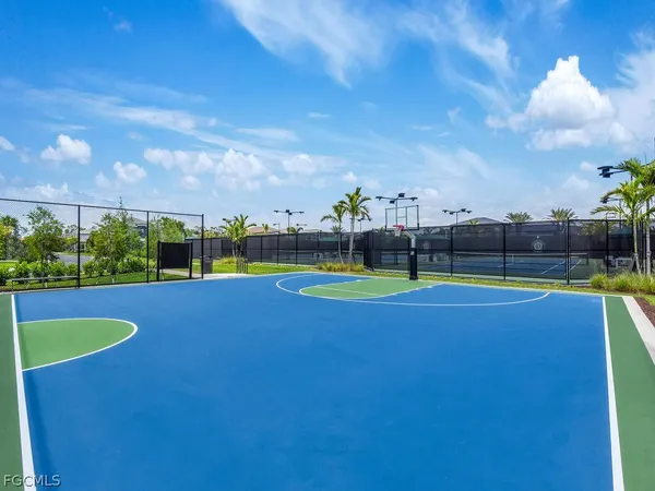 a kitchen with kitchen island a refrigerator and a sink