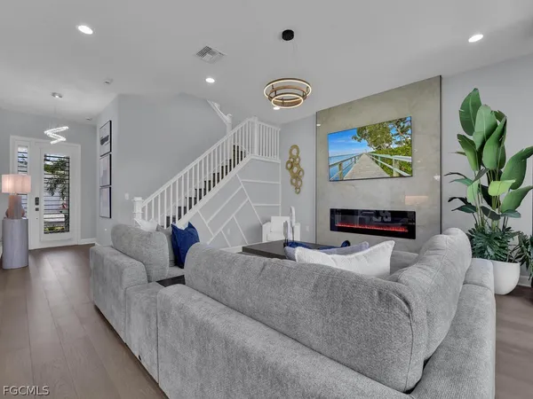 a living room with furniture and a potted plant