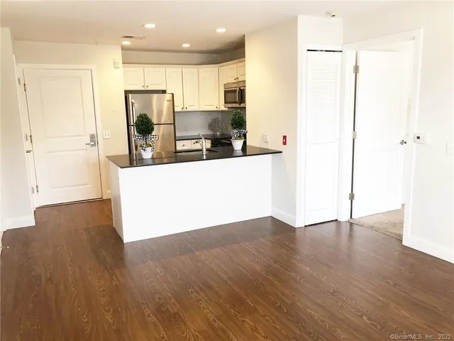 a view of a kitchen with wooden floor