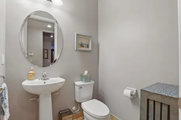 a bathroom with a toilet a sink and mirror