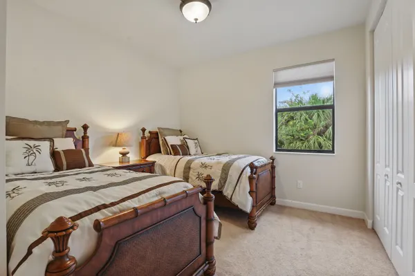 a bedroom with two beds and a window