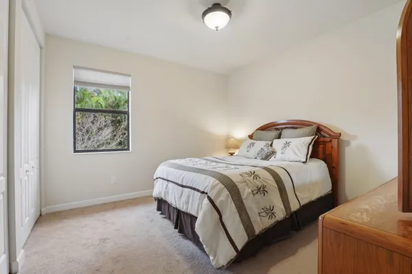 a bedroom with a bed lamp and window