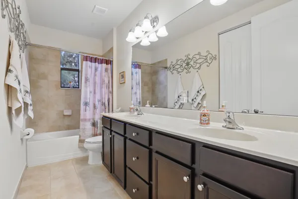 a bathroom with a double vanity sink mirror double vanity tub and shower