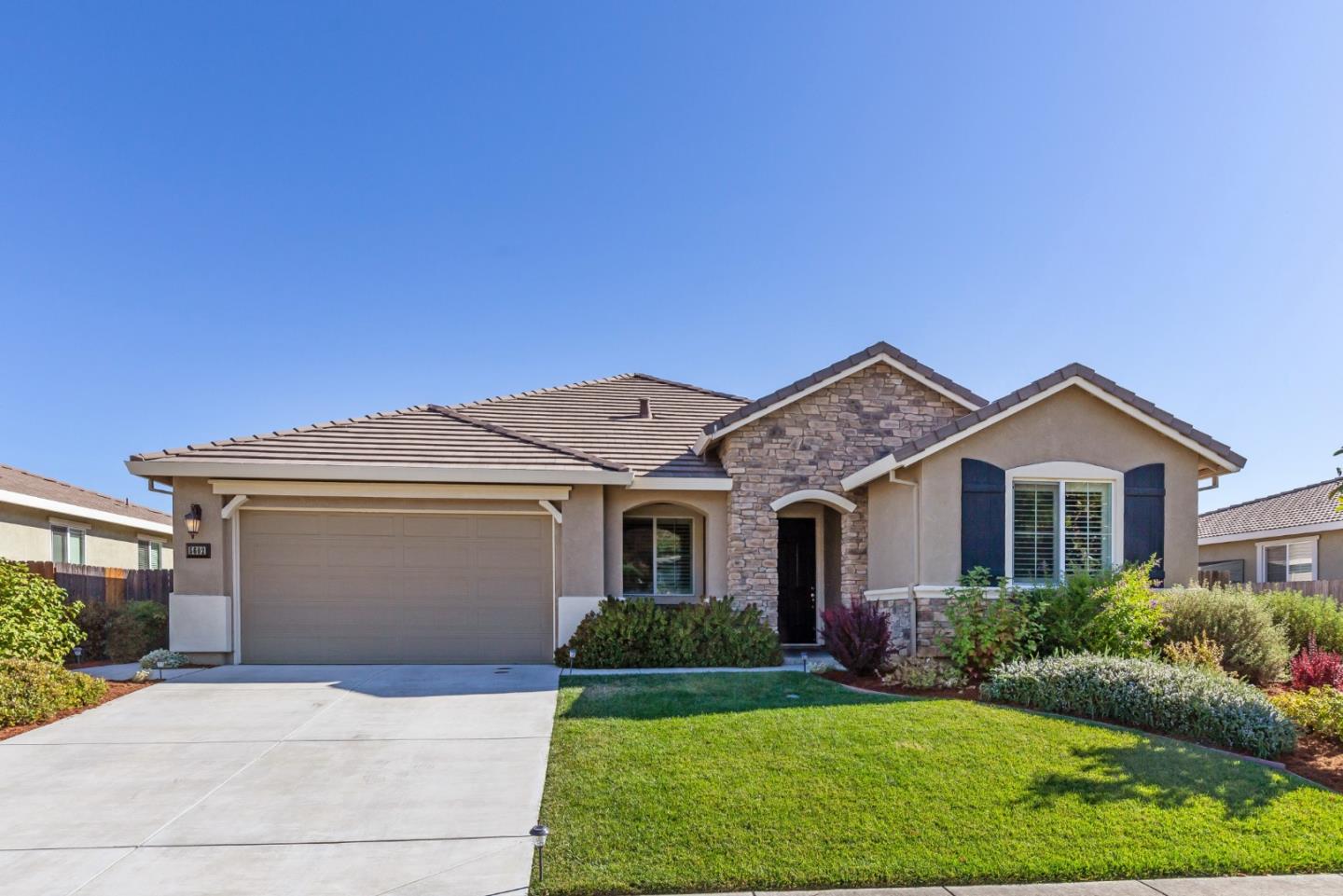 5602 Mesa Road Gilroy, CA 95020 - Photo 1 of 23 a front view of a house with a yard and garage