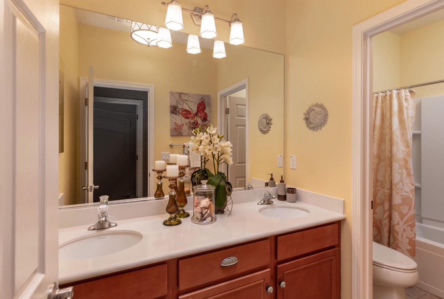 5602 Mesa Road Gilroy, CA 95020 - Photo 17 of 23 a bathroom with a granite countertop sink a toilet and a mirror