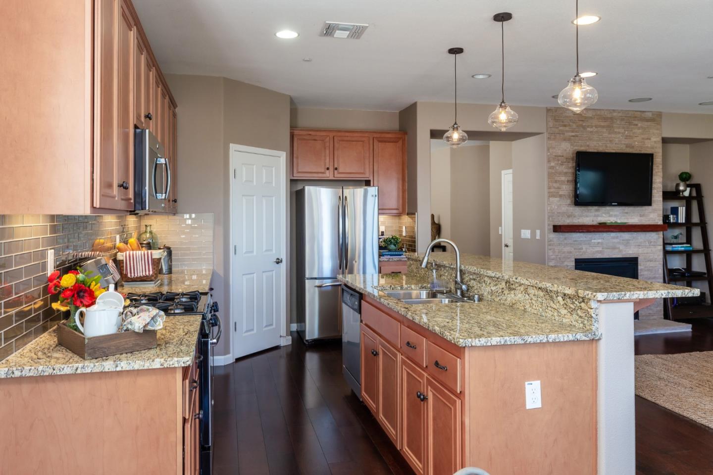 5602 Mesa Road Gilroy, CA 95020 - Photo 9 of 23 a kitchen with stainless steel appliances granite countertop a sink refrigerator and microwave