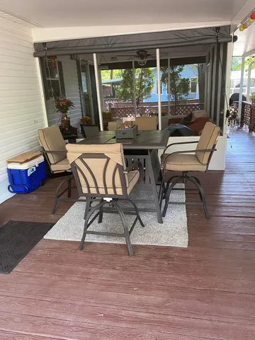 a view of a patio with table and chairs