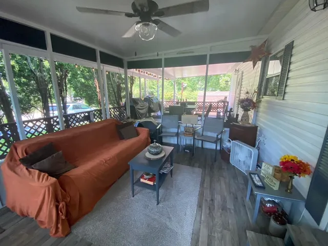 a living room with furniture and a floor to ceiling window