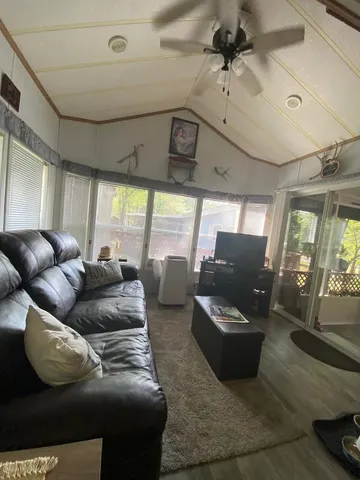 a living room with furniture and a floor to ceiling window