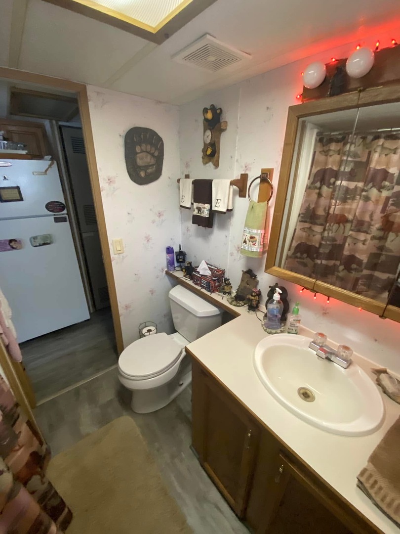 2795 East 28th Road Marseilles, IL 61341 - Photo 25 of 35 a bathroom with a toilet sink and mirror