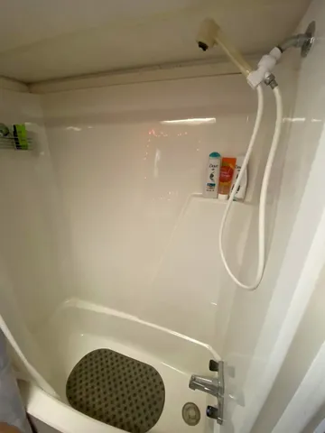a bathroom with a window and a shower
