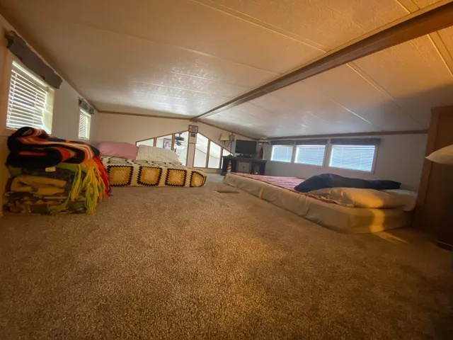 a bedroom with a bed and ceiling fan