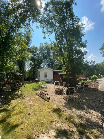 a view of a backyard with sitting area