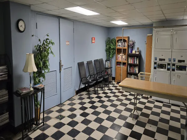 a bedroom with a bed and a book shelf