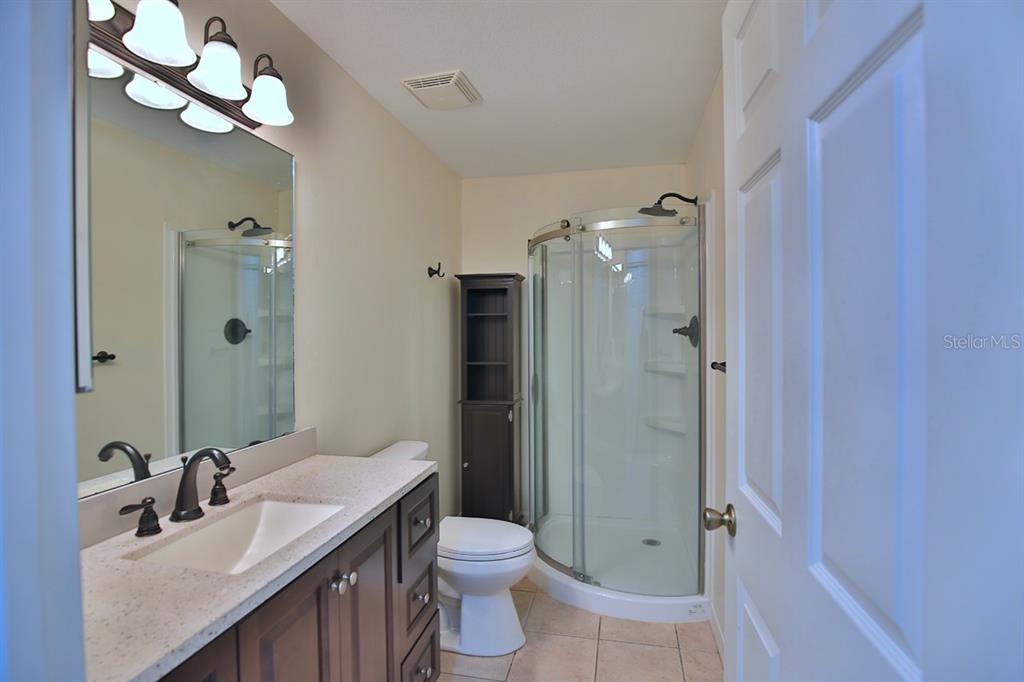12219 Southwest 26th Street Ocala, FL 34481 - Photo 13 of 63 a bathroom with a double vanity sink mirror and toilet