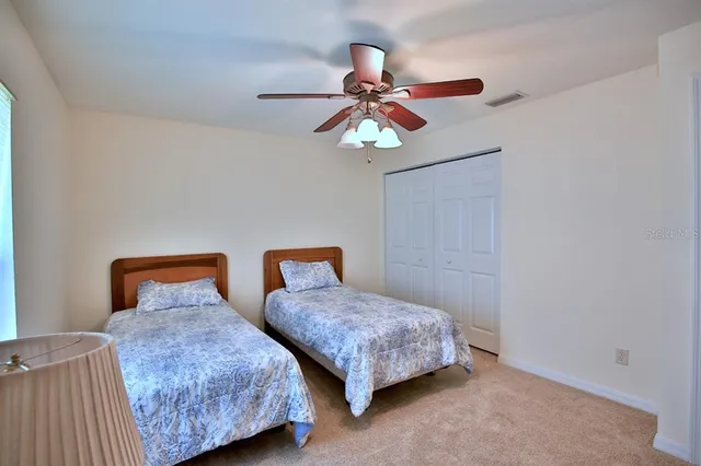 a view of a house with a big yard and large trees