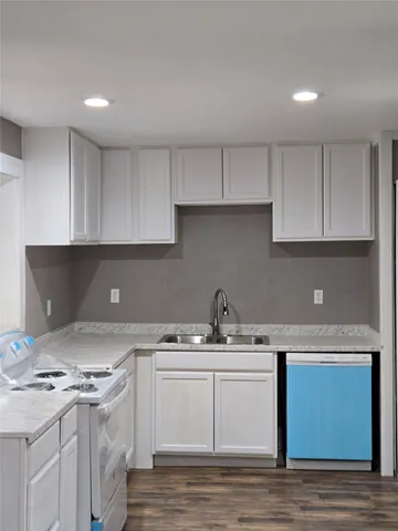 a kitchen with a sink stove and cabinets
