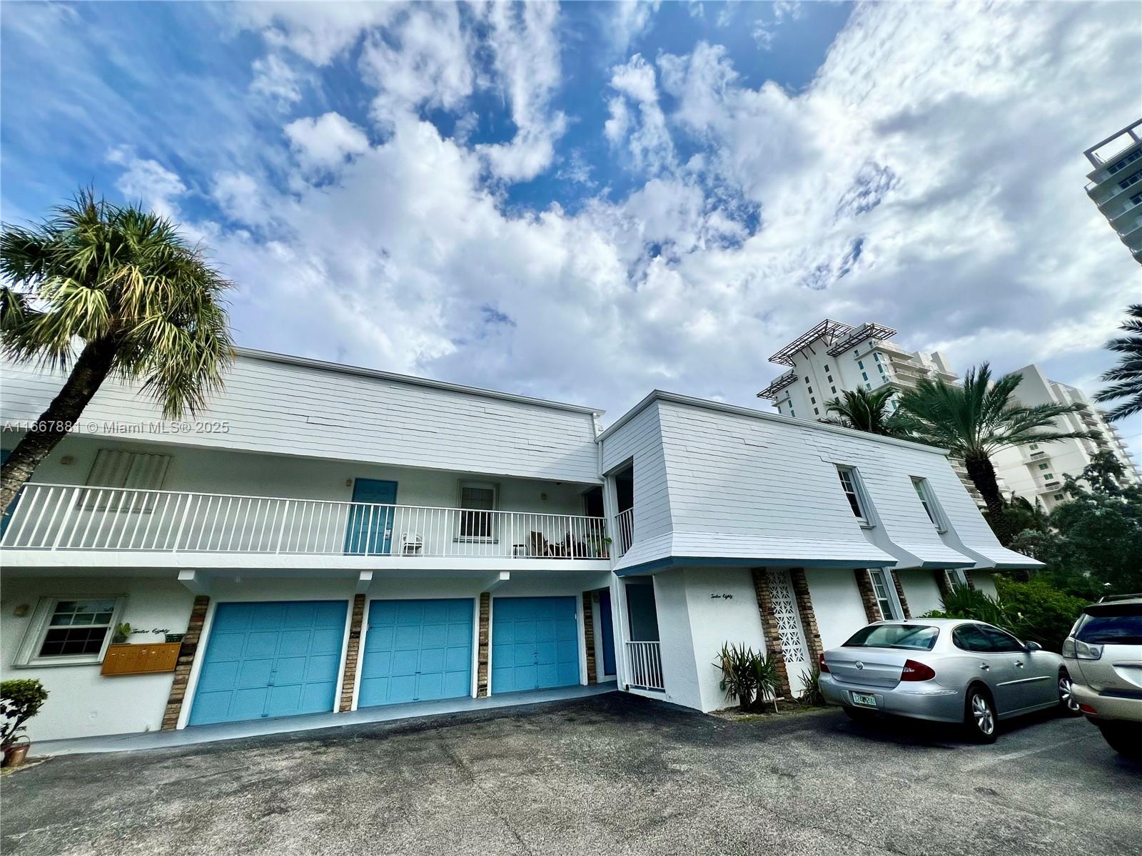 1280 Surf Road, Unit 103 Singer Island, FL 33404 - Photo 1 of 55 a view of a car park in front of house