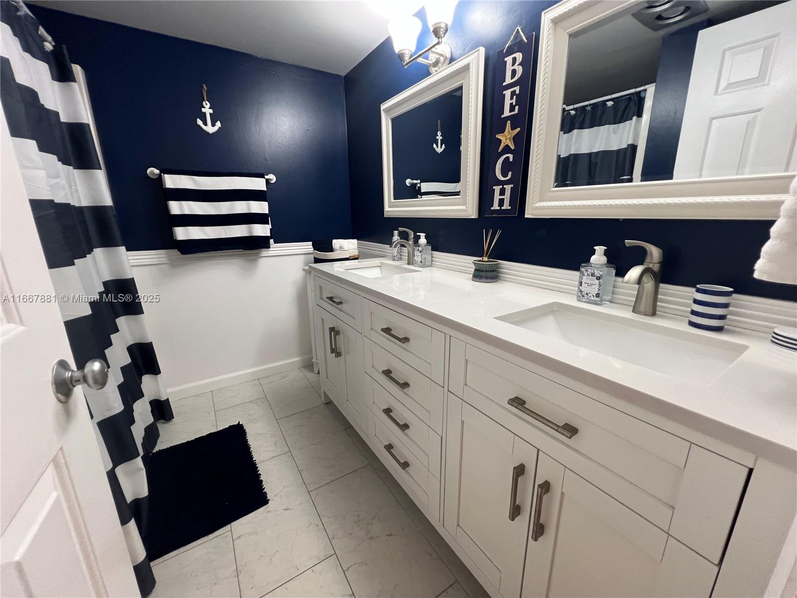 1280 Surf Road, Unit 103 Singer Island, FL 33404 - Photo 12 of 55 a bathroom with a sink and a mirror