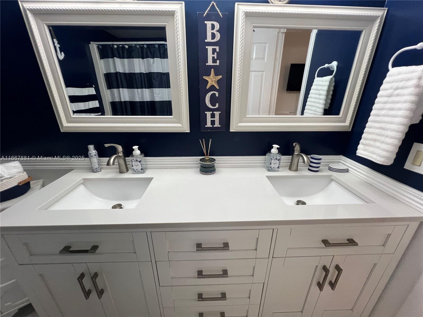 1280 Surf Road, Unit 103 Singer Island, FL 33404 - Photo 15 of 55 a bathroom with double vanity sink and two mirror