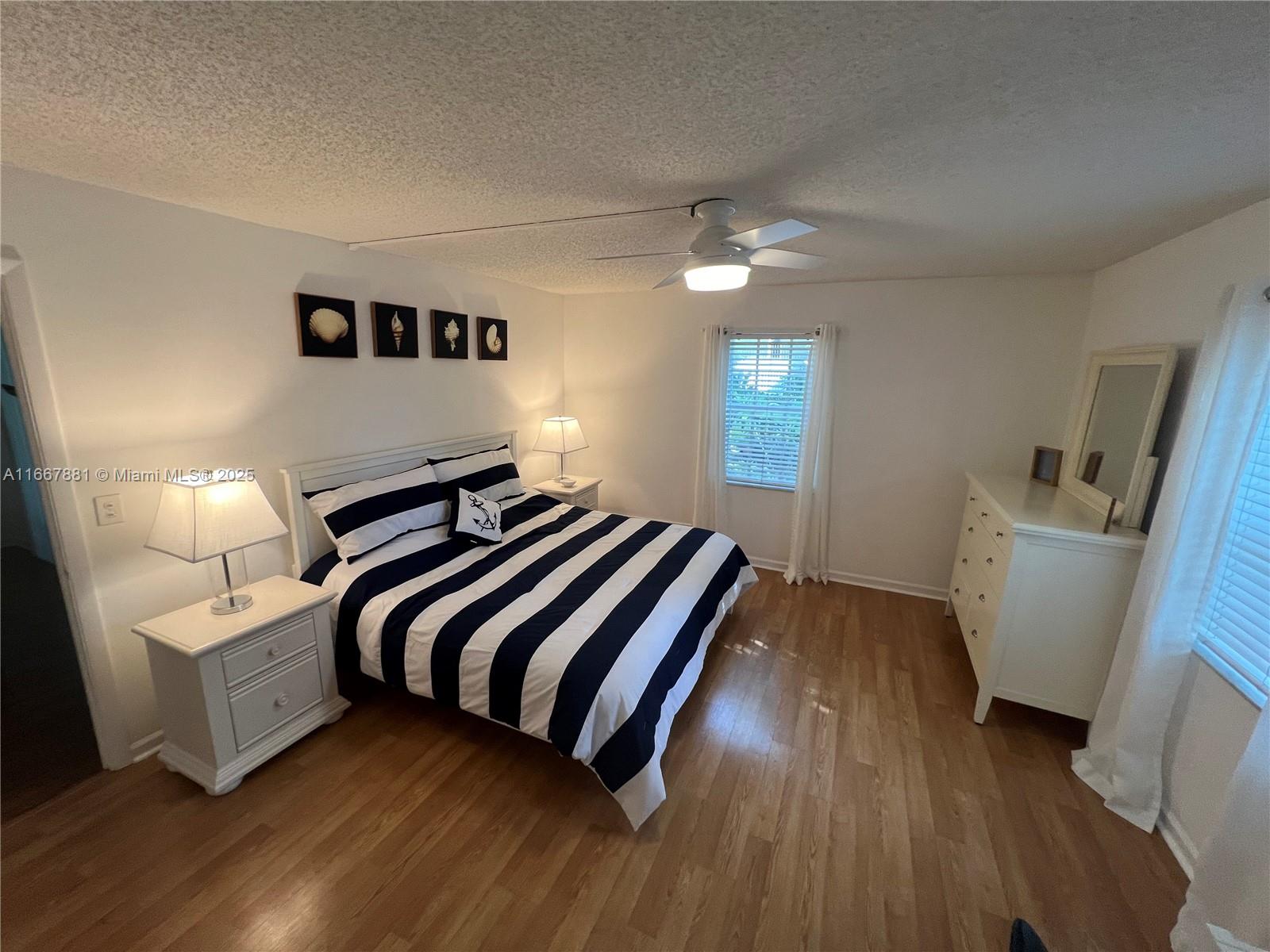 1280 Surf Road, Unit 103 Singer Island, FL 33404 - Photo 17 of 55 a bedroom with a bed and a large mirror