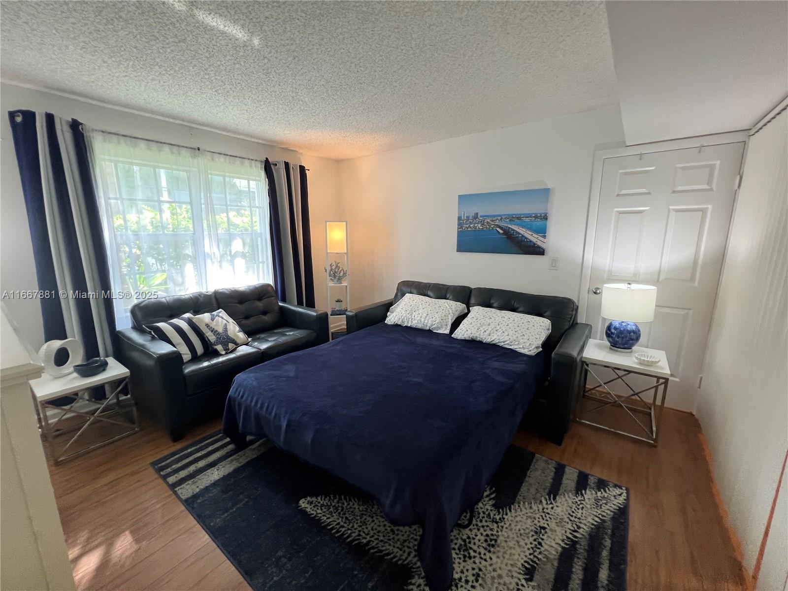 1280 Surf Road, Unit 103 Singer Island, FL 33404 - Photo 30 of 55 a bedroom with furniture and a large window