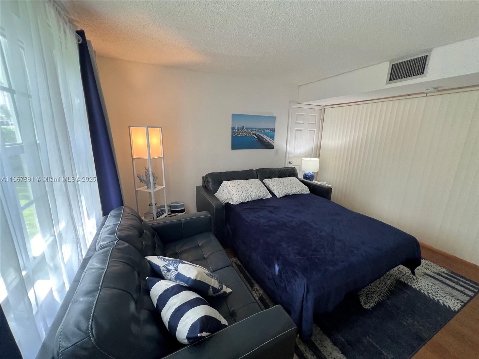 1280 Surf Road, Unit 103 Singer Island, FL 33404 - Photo 31 of 55 a bedroom with bed and window
