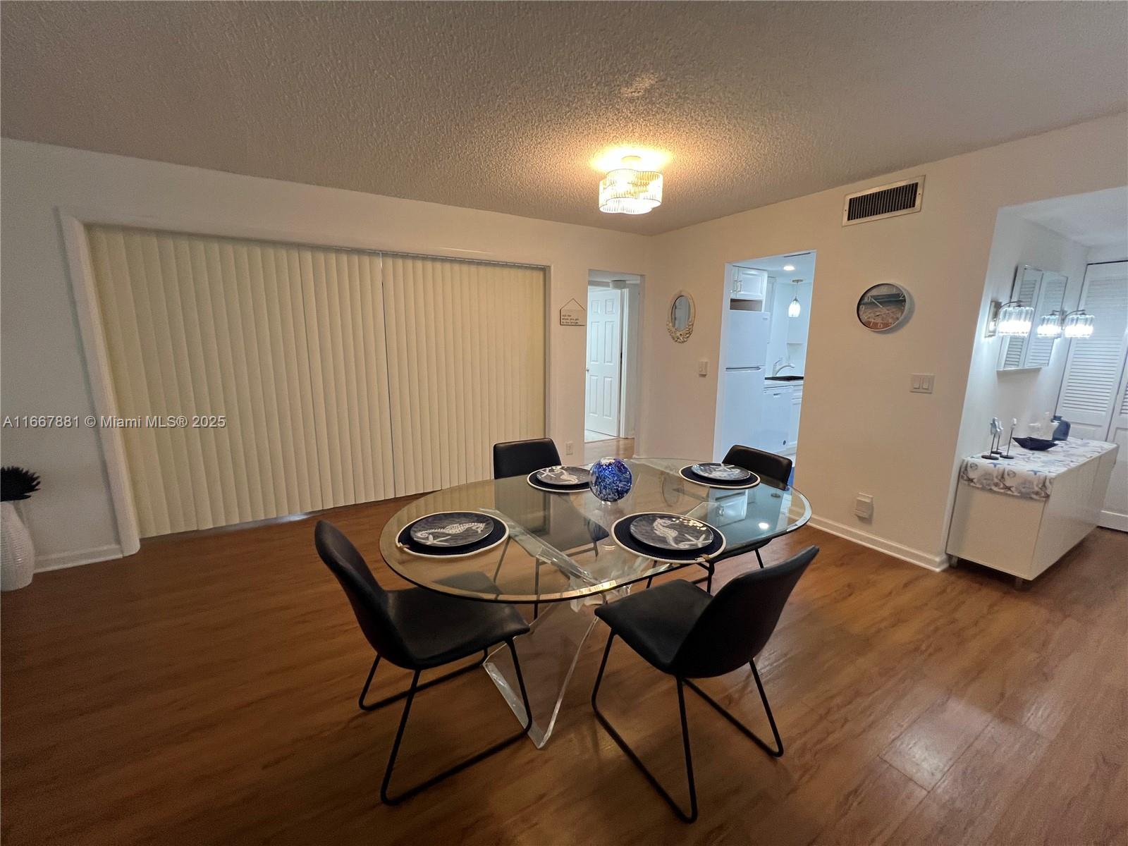 1280 Surf Road, Unit 103 Singer Island, FL 33404 - Photo 33 of 55 a view of a dining room with furniture and wooden floor