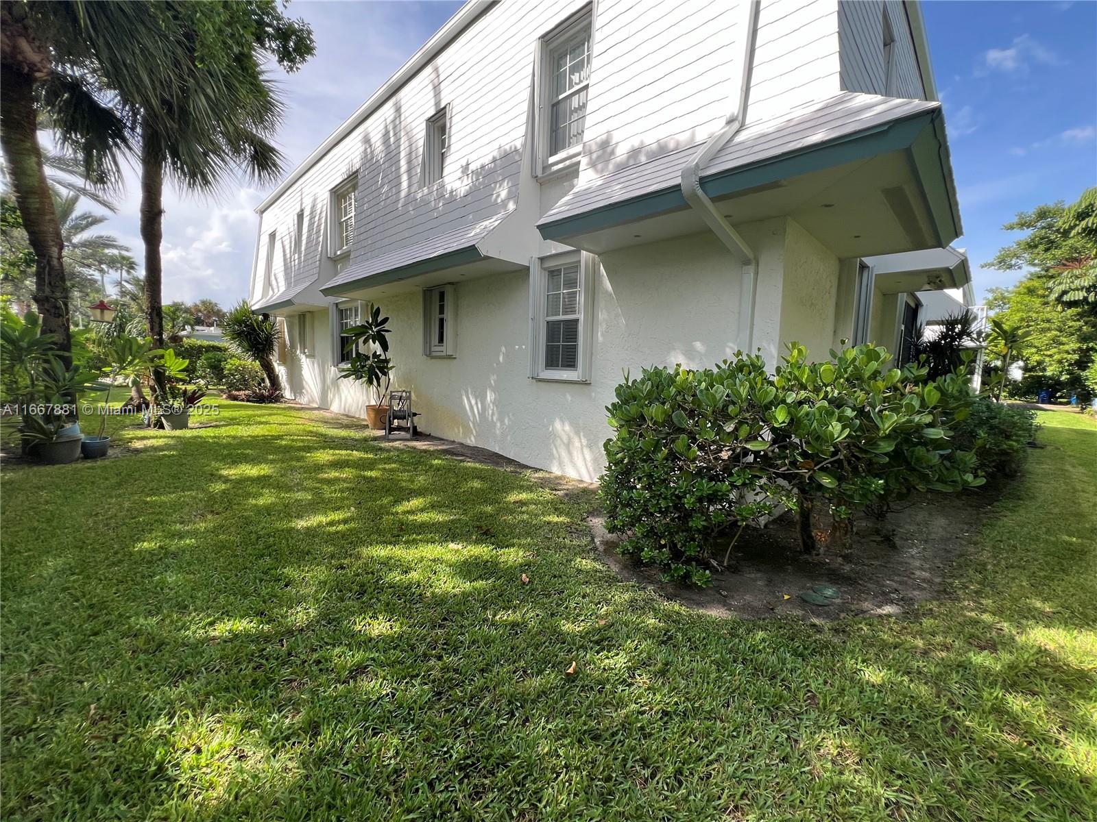 1280 Surf Road, Unit 103 Singer Island, FL 33404 - Photo 46 of 55 a view of a house with a yard and plants